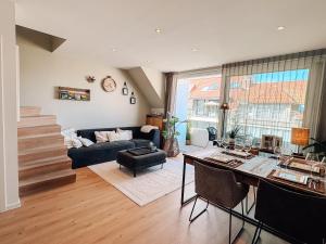 a living room with a couch and a table at la MERéMOI - Duplex Knokke with balcony and free parking in Knokke-Heist +31 photos