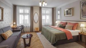 a bedroom with a large bed and a couch at SeNo6 Apartments in Prague