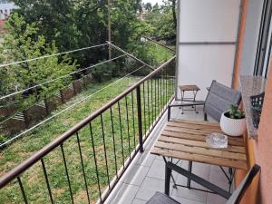 a balcony with a wooden bench and a view at SAN MARKO 2 in Lovran