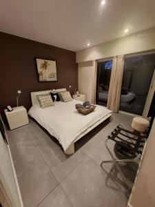 a bedroom with a large white bed and a window at VILLA COLINA Cannes Mandelieu in Mandelieu-La Napoule +99 photos