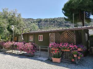 a house with flowers on the side of it at Camping Roma in Ventimiglia