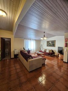 a large living room with a couch and a table at Villa Dourada in Porto Santo