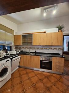 a kitchen with a sink and a dishwasher at Villa Dourada in Porto Santo