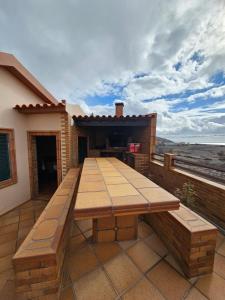 a wooden bench sitting on top of a patio at Villa Dourada in Porto Santo