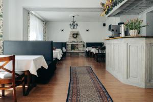 a dining room with two tables and a fireplace at Willa Pałacyk in Świeradów-Zdrój