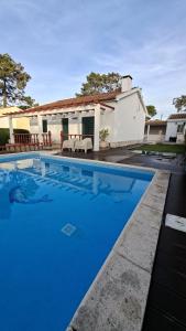 a blue swimming pool in front of a house at Vivenda Prazeres in Sesimbra