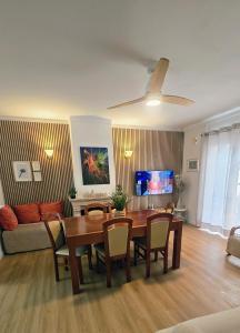 a living room with a table and a couch at Vivenda Prazeres in Sesimbra