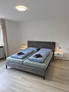 a bedroom with a bed with two towels on it at Ferienwohnung KönigSonne in Lauda-Königshofen