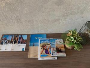 a bunch of magazines sitting on a table at ALandGIO Smart Stay in Cavallino-Treporti +39 photos