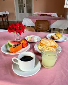 a table with plates of food and a cup of coffee at Hotel Valenciano in Valença