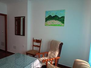 a room with a table and two chairs and a painting at Casa Feria in Algodonales +11 photos