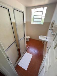 a bathroom with a shower and a toilet and a window at Hotel Valenciano in Valença +15 photos
