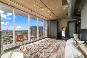 a bedroom with a large bed and a large window at Hollywood Beach Speakeasy Condo with Pool in Hollywood
