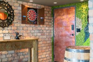 a brick wall with a door and a dart board at Hollywood Beach Speakeasy Condo with Pool in Hollywood