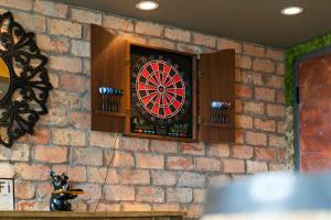 a dart board on a brick wall at Hollywood Beach Speakeasy Condo with Pool in Hollywood +51 photos