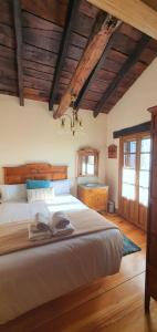 a bedroom with a large bed and wooden ceilings at Caserio Gaztelu in Gaztelu