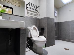 a bathroom with a toilet and a sink at Casa Yu in Hat Yai +29 photos