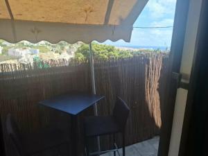 a table and chairs on a balcony with a view at Le Rocher 3 in Ermoupoli