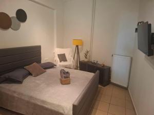 a bedroom with a bed with a basket on it at Le Rocher 3 in Ermoupoli