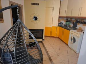 a kitchen with a washer and dryer at Le Rocher 3 in Ermoupoli +6 photos