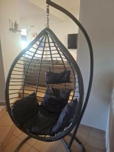 a swing with two chairs in a room at Le Rocher 3 in Ermoupoli