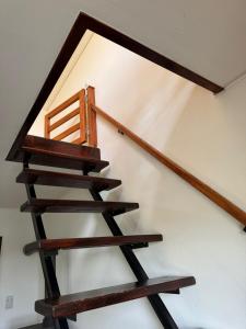 a wooden staircase with a wooden chair on it at Fruškogorska bajka in Velika Remeta