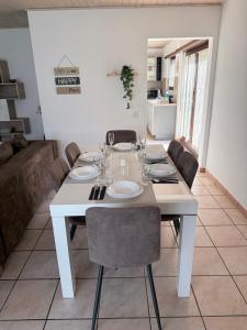 a white table with chairs and a white dining room at Angolo del Tramonto in Gambarogno