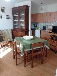 a kitchen with a table and chairs with a table and a plate on it at Casa Bonaccorsi in Civitella Del Lago