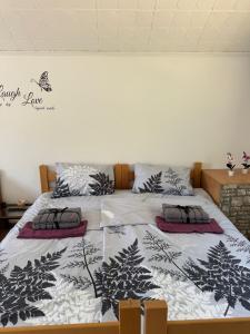 a bedroom with two beds with black and white pillows at Fruškogorska bajka in Velika Remeta