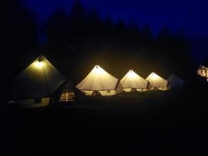 a row of tents lit up at night at Penzion Eška s Pivovarem MJ in Jince