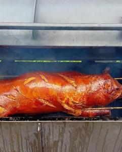 a turkey is cooking on a grill in an oven at Penzion Eška s Pivovarem MJ in Jince