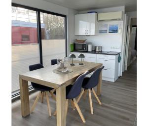 a kitchen with a wooden table and chairs at Floating 44 in Xanten - Boot 2 in Xanten +30 photos