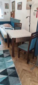 a living room with a table and a bed at Adikati Lak in Bük