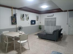 a living room with a table and a couch at hatyai homestay greenway orkar in Hat Yai