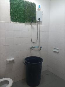 a bathroom with a toilet and a trash can at hatyai homestay greenway orkar in Hat Yai