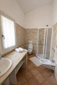 a bathroom with a shower and a sink and a toilet at La casa di Fedra in Imperia