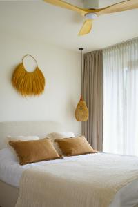 a bedroom with a bed and a ceiling fan at Balimood Stay in Palanga
