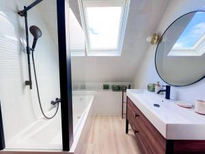 a bathroom with a sink and a shower and a mirror at Ty ar Vigouden - maison de vacances in Loctudy +33 photos