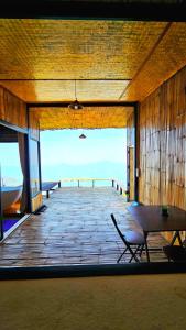 a large wooden deck with a table and a bench at Mon Ngo misty haven B2 in Ban Mae Ta Man +9 photos
