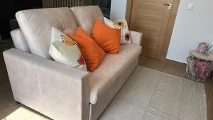 a white couch with pillows on it in a living room at El Rincón del Castillo I in Caravaca de la Cruz