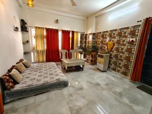 a bedroom with a bed and a table and chairs at Perfect for Homely Atmosphere in kolkata
