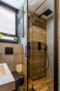 a shower with a glass door next to a sink at Edinburgh Centre - Holyrood Apartment in Edinburgh +13 photos