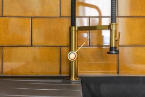 a brass pipe attached to a brick wall at Edinburgh Centre - Holyrood Apartment in Edinburgh