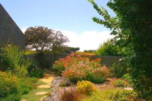 a garden with colorful flowers and a fence at Cadwalader House in Sea Ranch