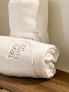 a stack of towels sitting on a wooden table at Terracotta House in Porto Santo