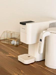 a white sewing machine sitting on a wooden table at Terracotta House in Porto Santo