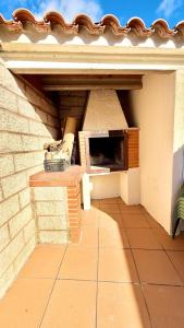 a building with a pizza oven on a patio at Casa Rural NEREA in Letux +11 photos
