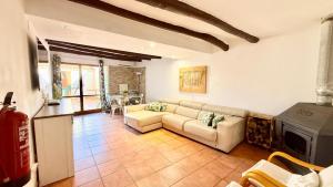 a living room with a couch and a stove at Casa Rural NEREA in Letux