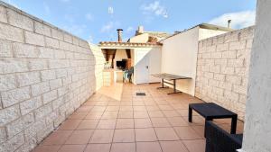 a brick wall with a bench on a patio at Casa Rural NEREA in Letux