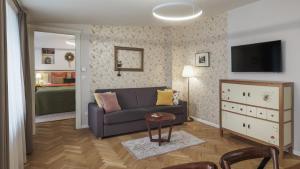 a living room with a couch and a bedroom at SeNo6 Apartments in Prague